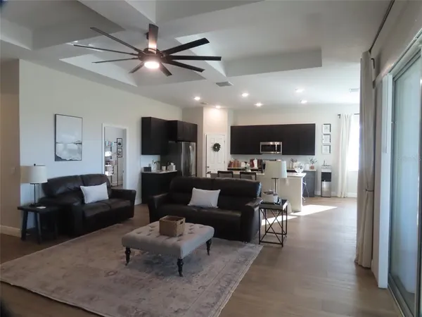 a living room with furniture and kitchen view