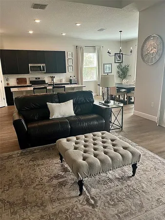 a living room with furniture and kitchen view