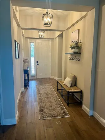 a bedroom with wooden floor and hallway