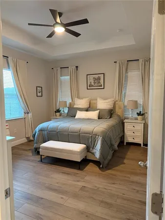 a spacious bedroom with a bed and a ceiling fan