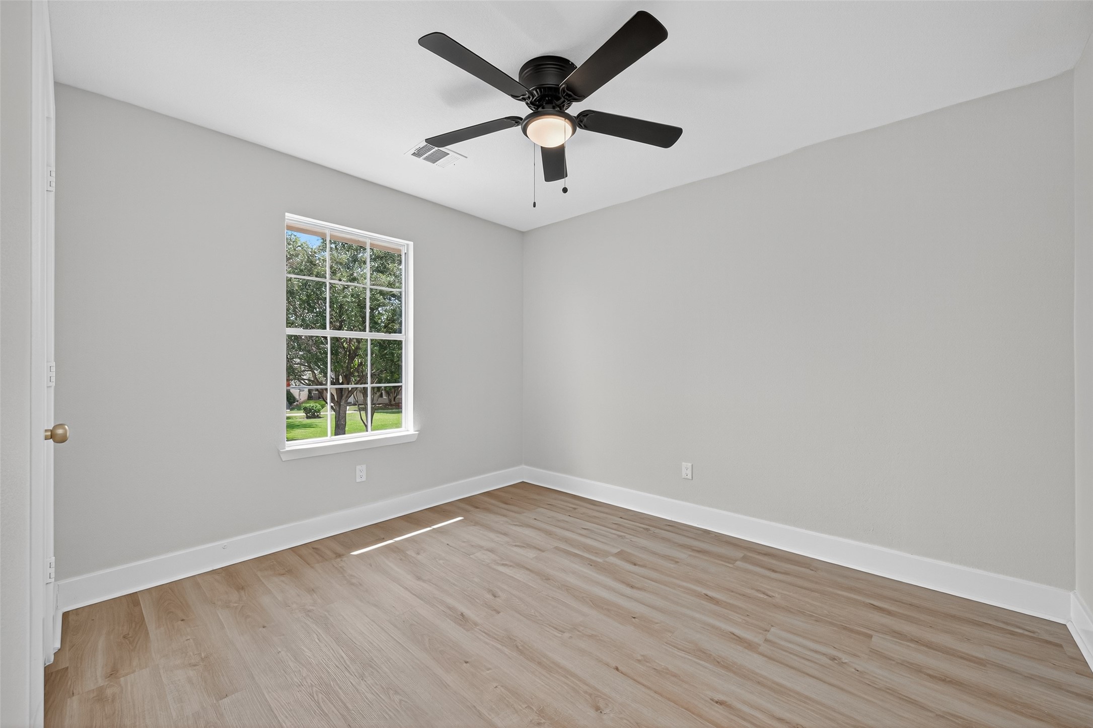 19515 Fletcher Way Drive Houston, TX 77073 - Photo 22 of 27 an empty room with wooden floor and windows