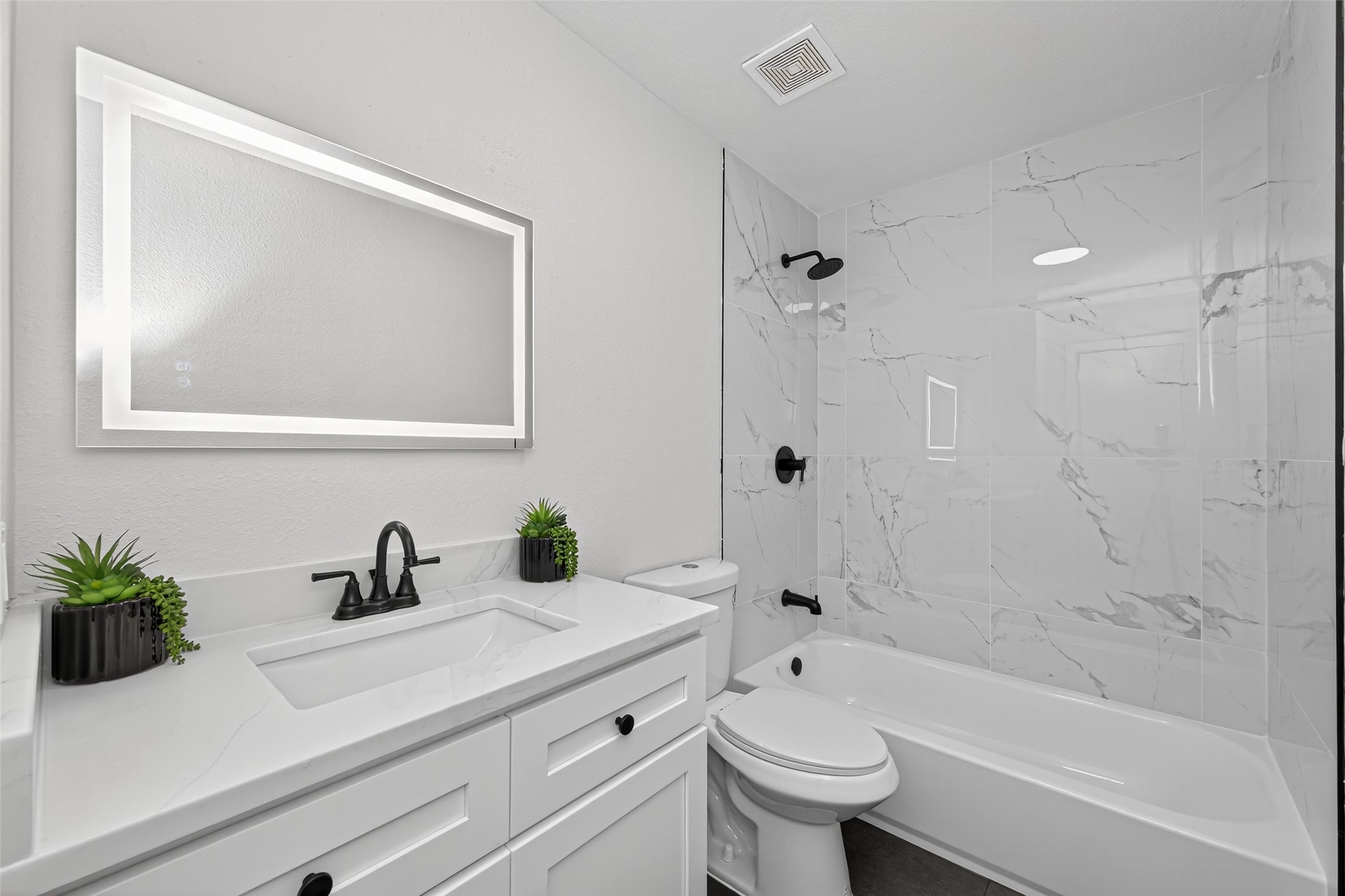 19515 Fletcher Way Drive Houston, TX 77073 - Photo 24 of 27 a bathroom with a sink a toilet a mirror a bathtub and shower