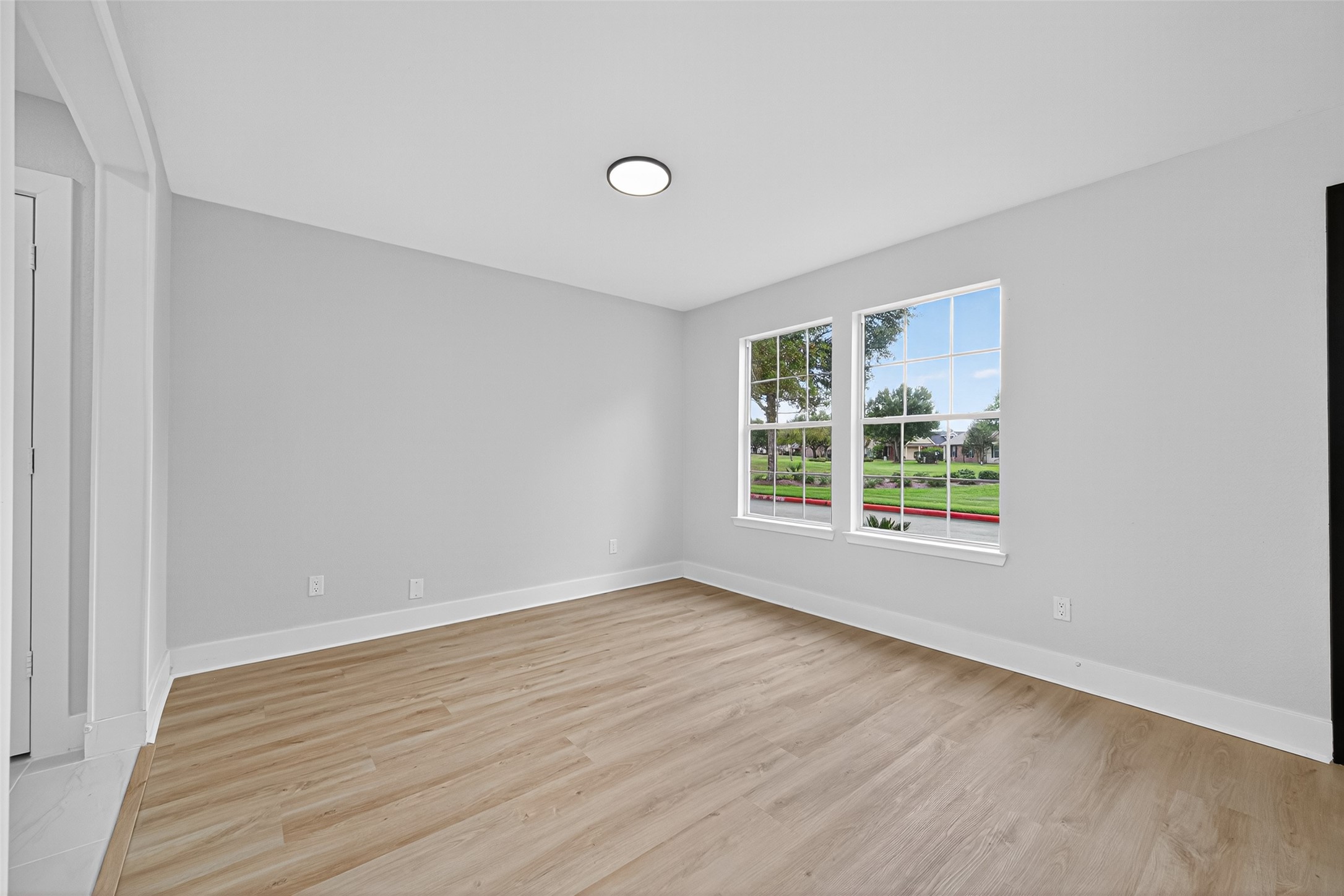 19515 Fletcher Way Drive Houston, TX 77073 - Photo 5 of 27 a view of an empty room with wooden floor and a window