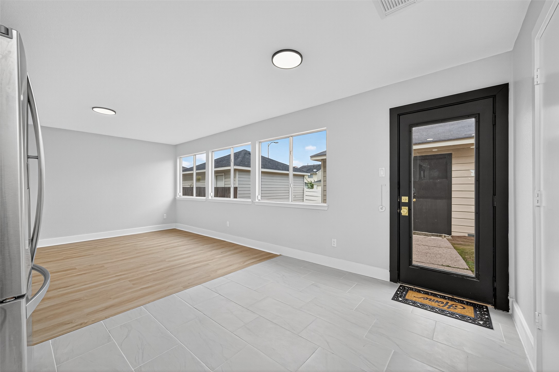 19515 Fletcher Way Drive Houston, TX 77073 - Photo 10 of 27 a view of an empty room with a window and wooden floor