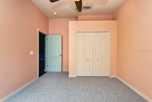 an empty room with closet area