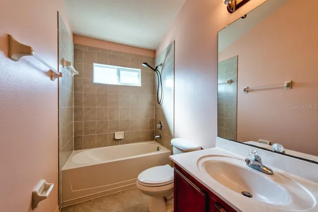 a bathroom with a sink toilet tub and shower