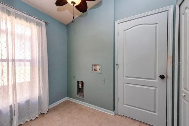 an empty room with closet and windows