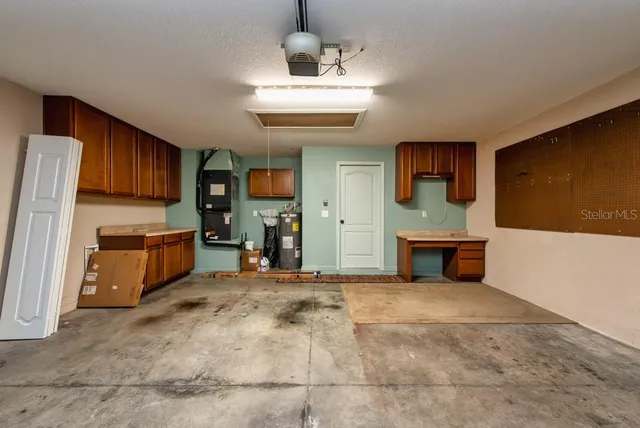 a view of a kitchen with a sink and a refrigerator