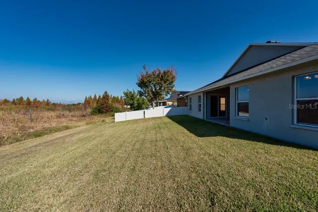 a view of a backyard of the house