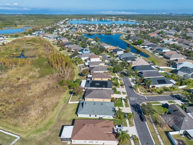 an aerial view of residential houses with outdoor space