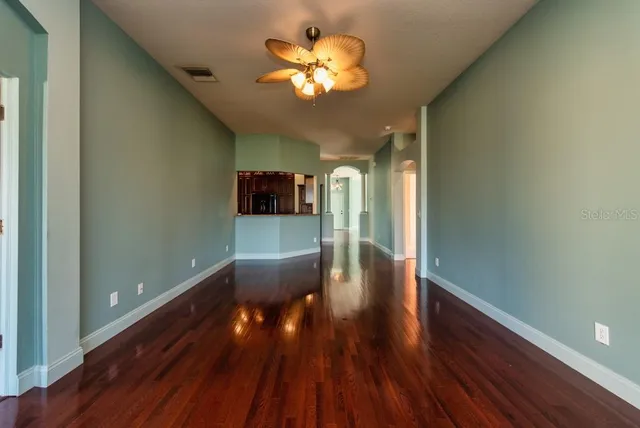 a view of empty room with wooden floor