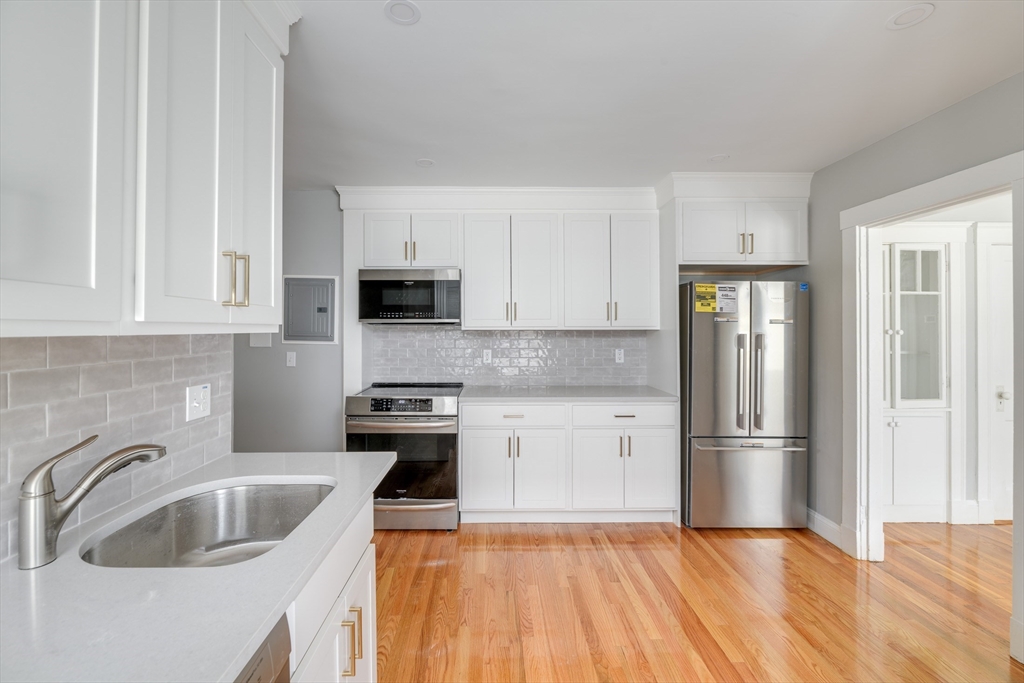 43 Mill Street, Unit 43A Quincy, MA 02169 - Photo 2 of 10 a kitchen with a refrigerator sink and cabinets
