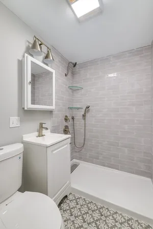 a bathroom with a sink toilet and shower