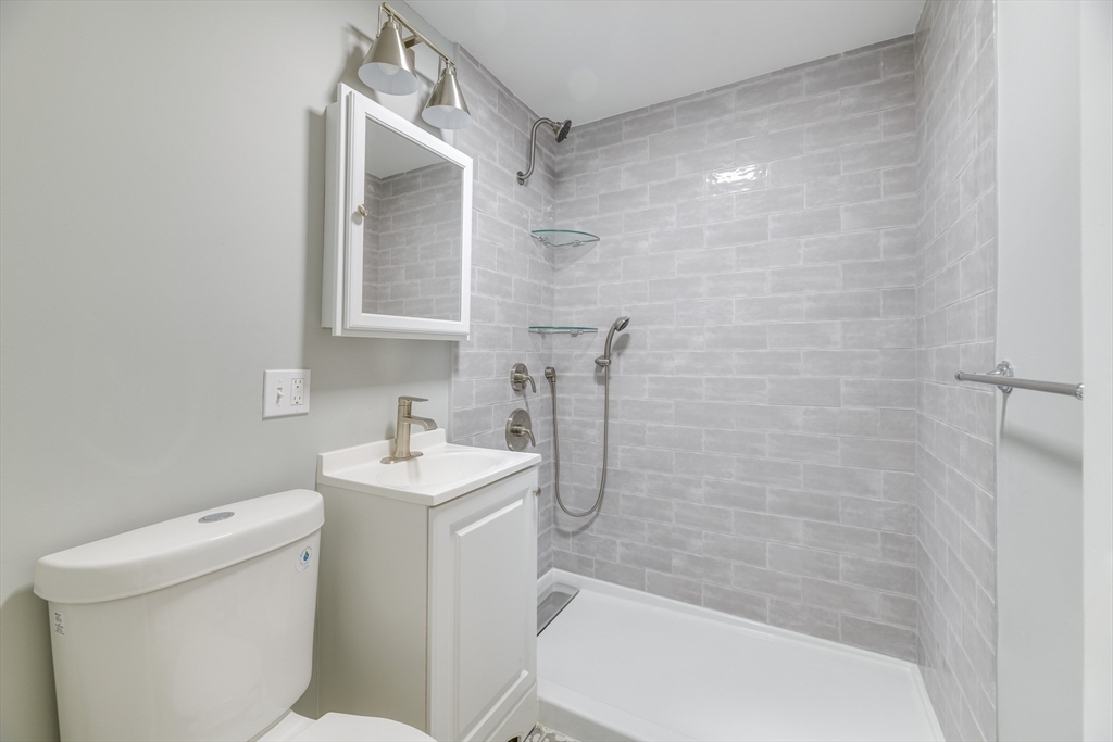 43 Mill Street, Unit 43A Quincy, MA 02169 - Photo 6 of 10 a bathroom with a sink toilet and shower