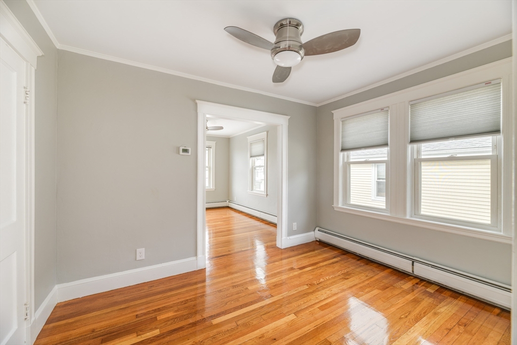 43 Mill Street, Unit 43A Quincy, MA 02169 - Photo 7 of 10 a view of an empty room with wooden floor and a window