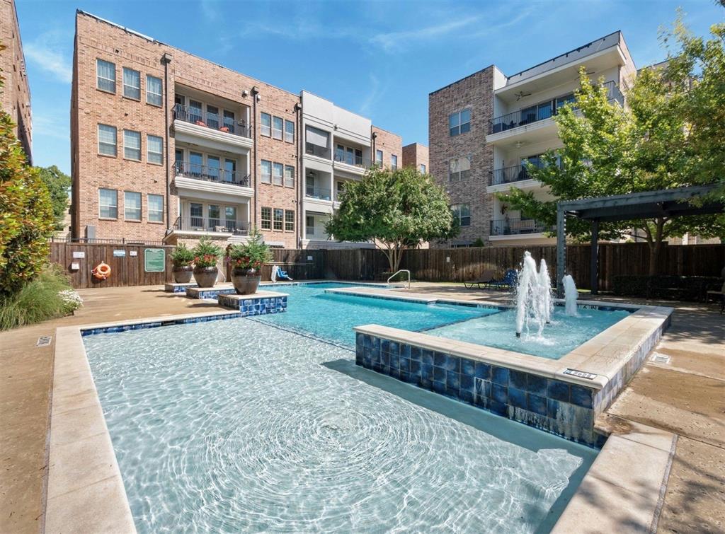 5001 Meridian Lane, Unit 2103 Addison, TX 75001 - Photo 26 of 26 Resort-style pool area featuring a water fountain, blue mosaic tile accents, and a surrounding paved deck