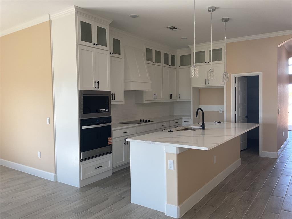 7354 Ne Creek Rice, TX 75155 - Photo 4 of 12 a kitchen with a sink and white cabinets