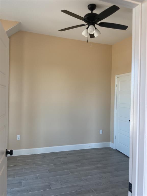 7354 Ne Creek Rice, TX 75155 - Photo 6 of 12 a view of a room with wooden floor and a ceiling fan