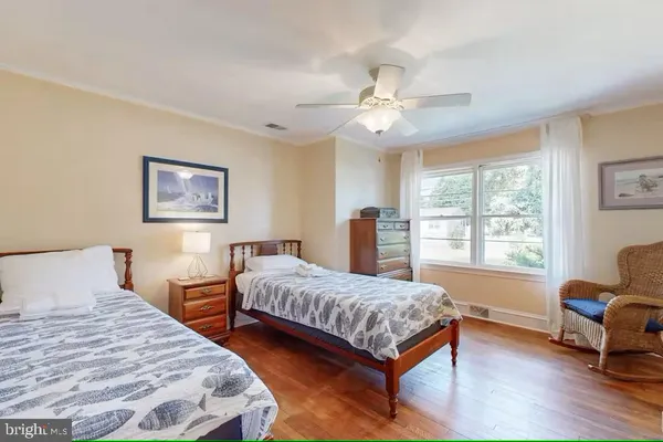 a bedroom with two beds and a large window