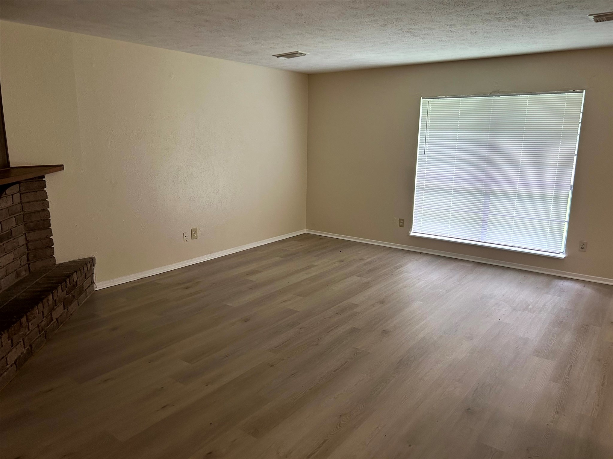 5018 Ridgecreek Drive Houston, TX 77053 - Photo 2 of 18 an empty room with wooden floor and windows