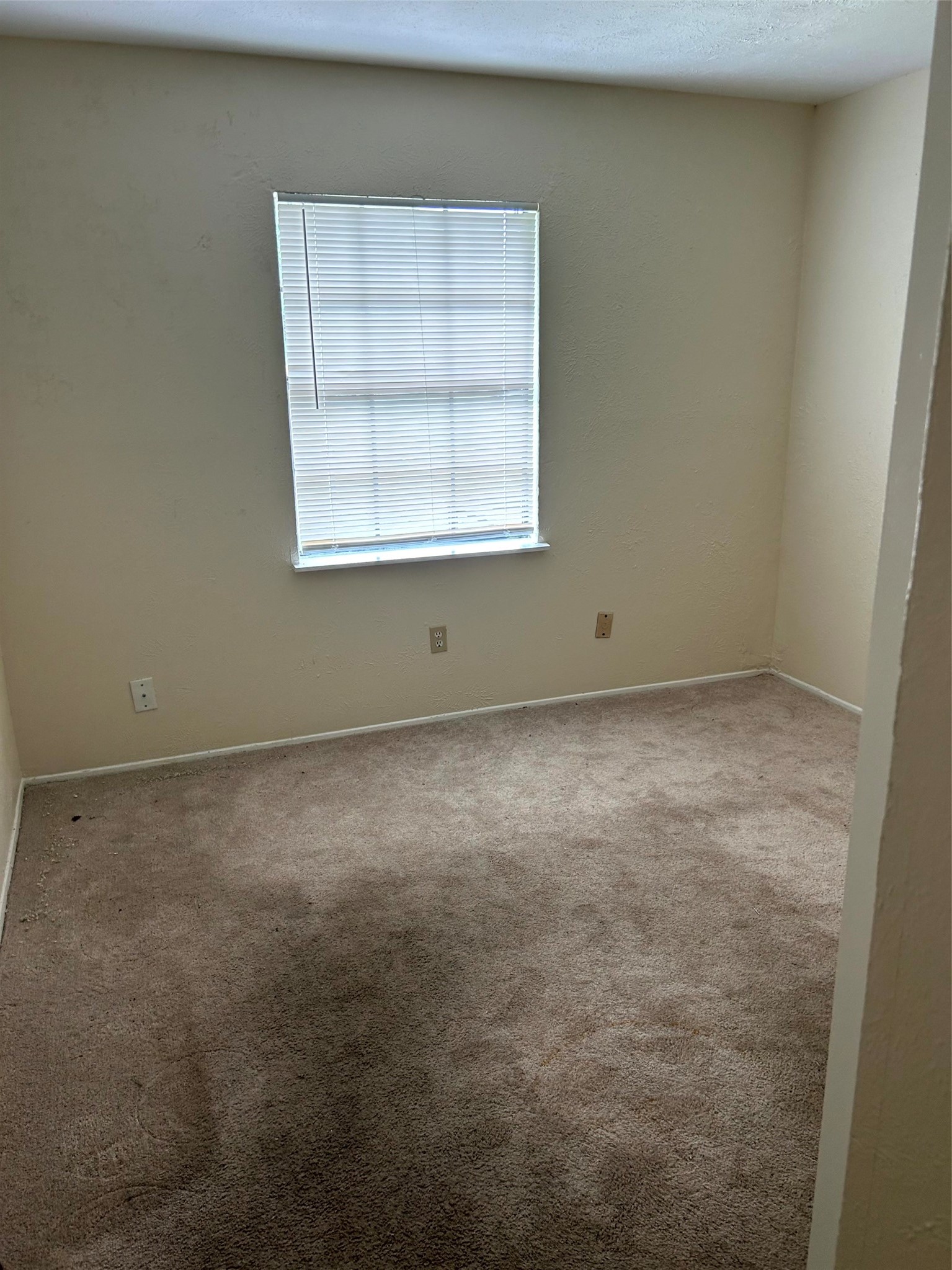 5018 Ridgecreek Drive Houston, TX 77053 - Photo 6 of 18 an empty room with a window
