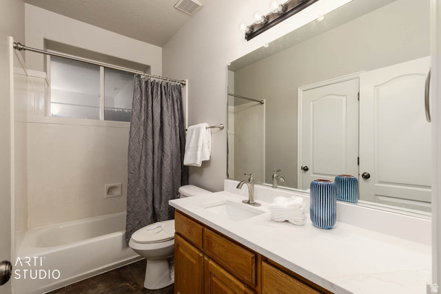 2158 Balboa Way St. George, UT 84770 - Photo 24 of 40 Bathroom with shower / bathtub combination with curtain, vanity, and a textured ceiling