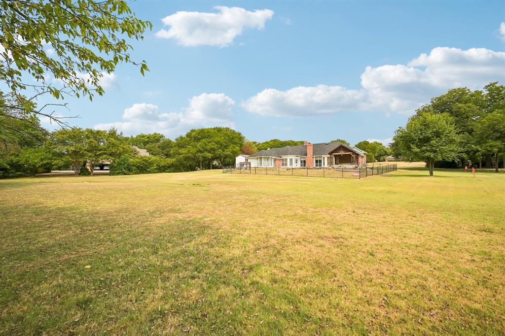1380 Meandro Ria Lane Fairview, TX 75069 - Photo 38 of 39 Expansive lawn featuring perimeter fencing and mature trees
