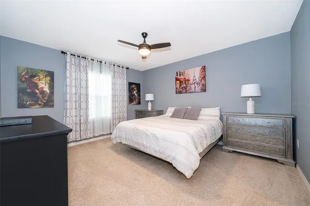 a spacious bedroom with a bed and a desk