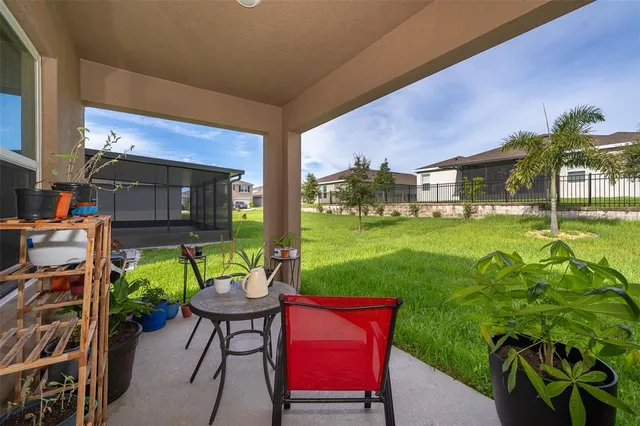 a backyard of a house with table and chairs