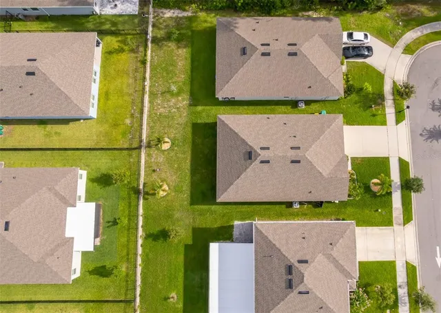 an aerial view of a house with a swimming pool