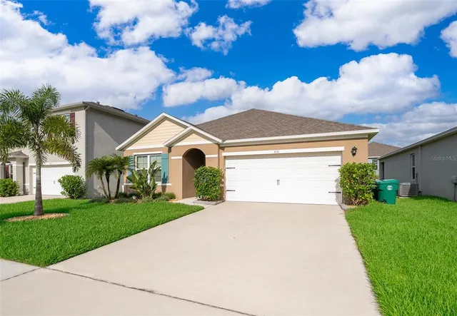 a view of a white house with a yard
