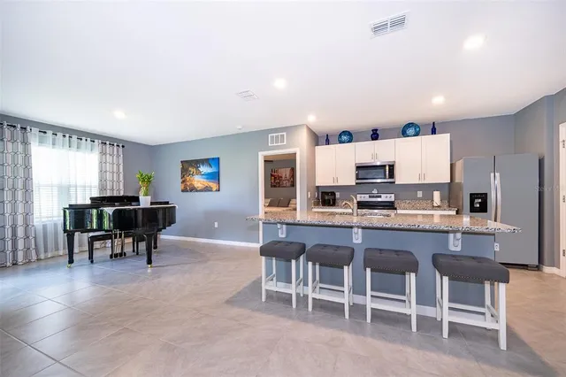 a large kitchen with a table and chairs