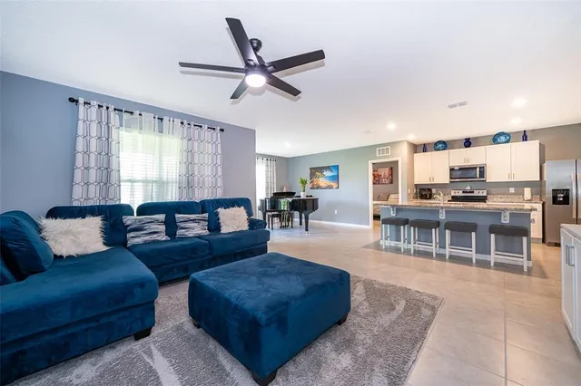a living room with furniture and kitchen view