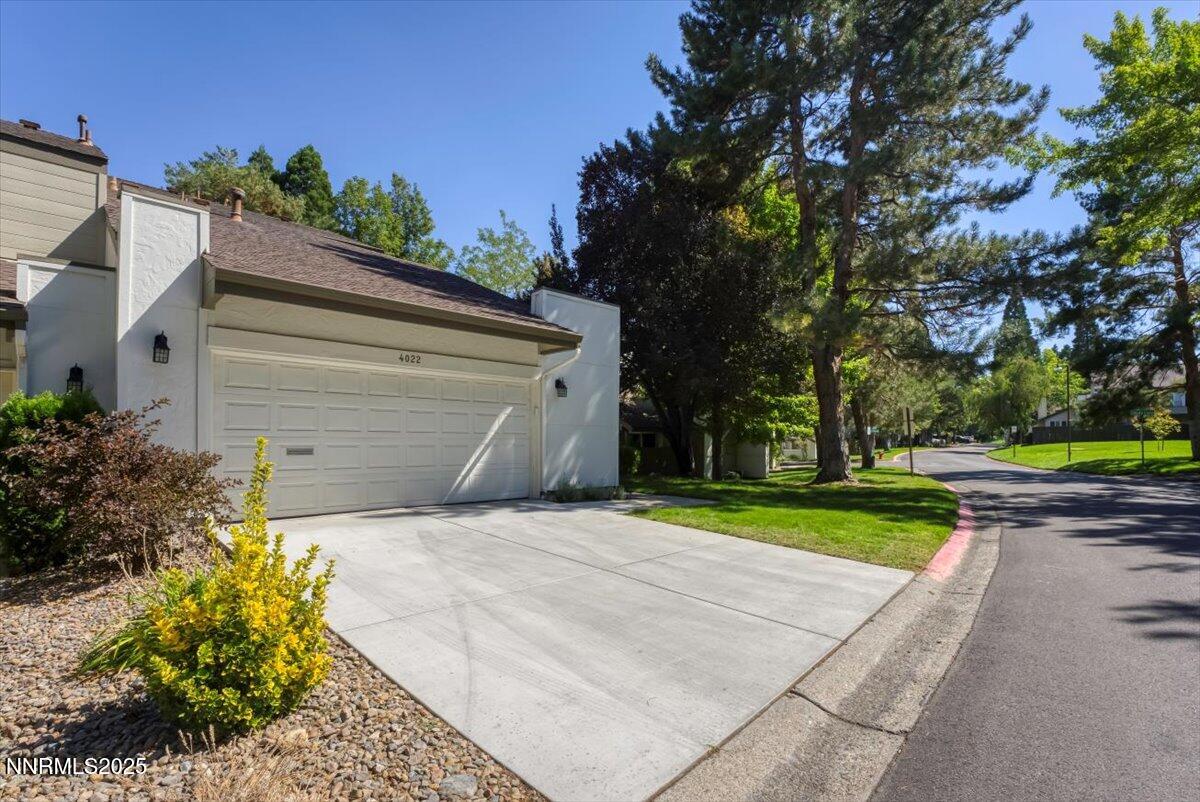 4022 Millbrook Lane Reno, NV 89509 - Photo 6 of 40 a front view of a house with a yard and garage