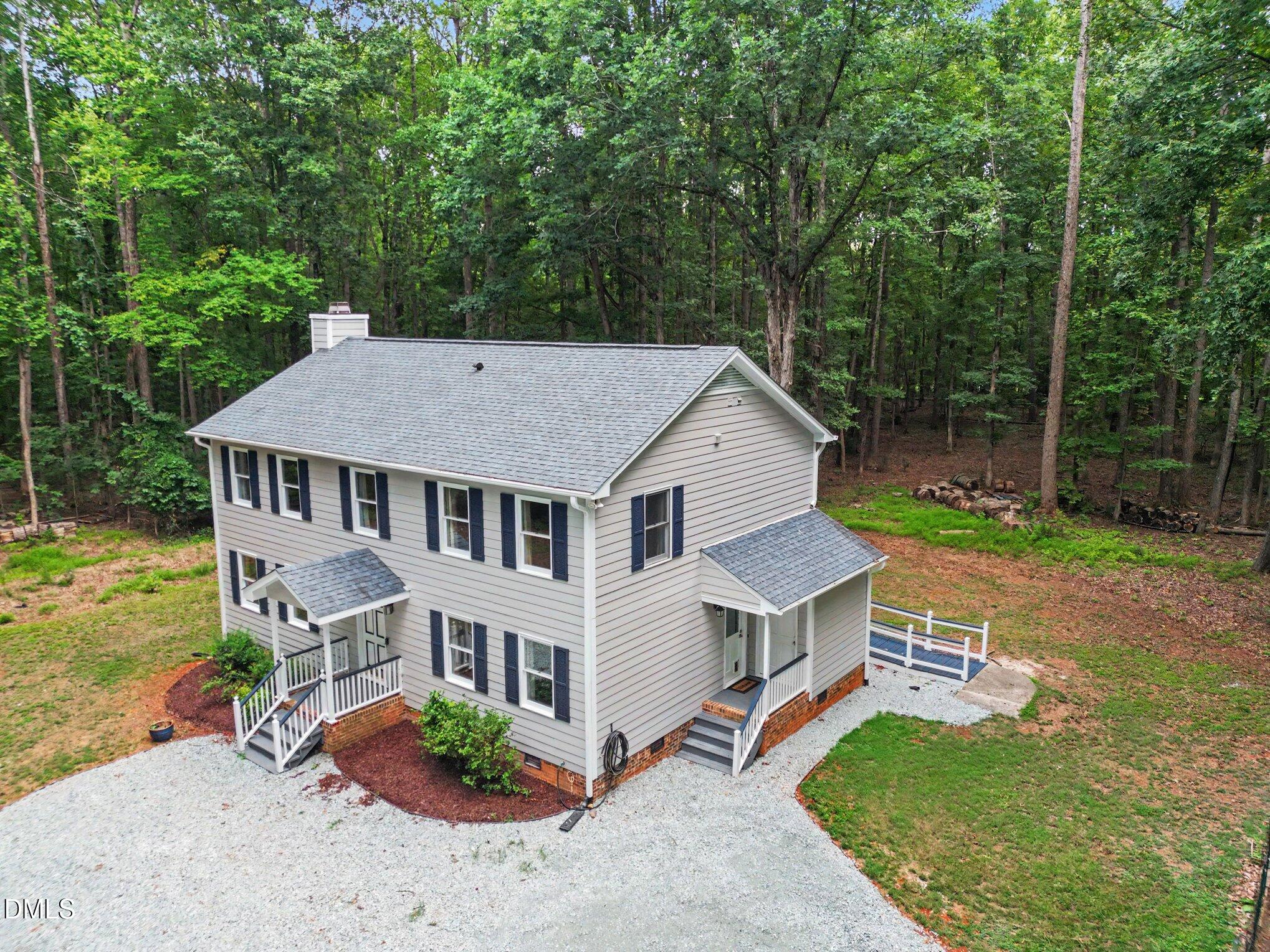 114 Oak Hollow Road Timberlake, NC 27583 - Photo 2 of 31 Two-story residence featuring light gray siding with dark contrasting shutters