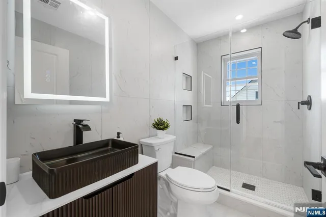 a bathroom with a toilet a sink and shower