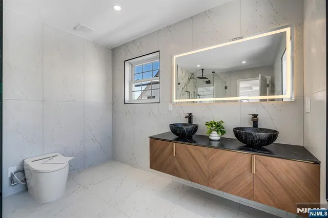 a living room with furniture and a mirror