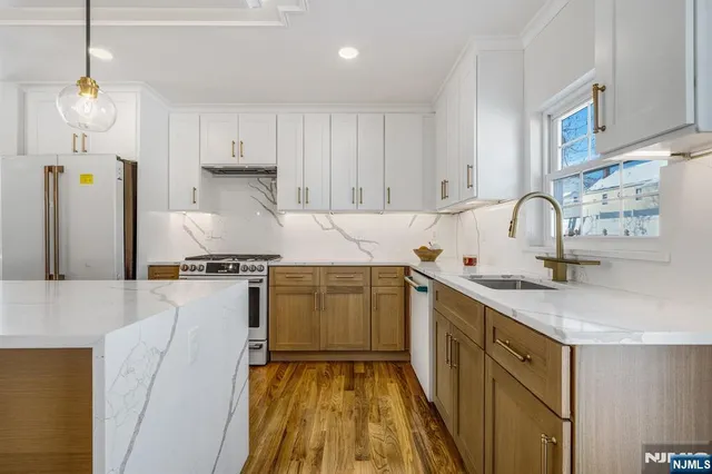 a kitchen with a sink stove and refrigerator