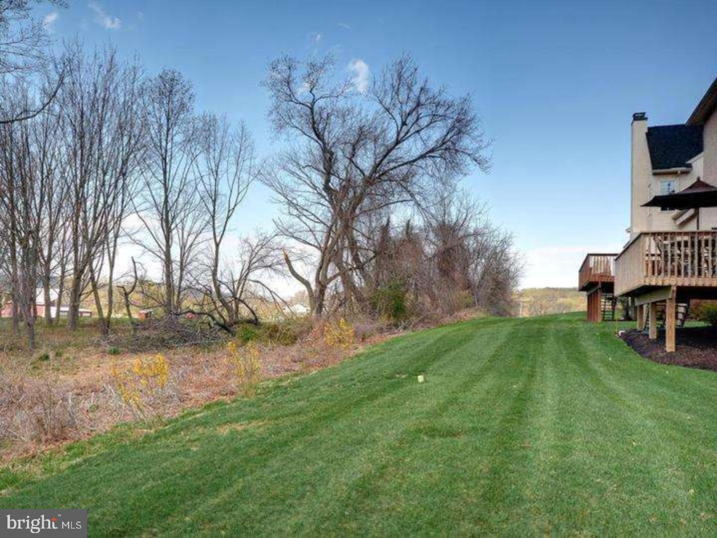 310 Waynebrook Drive Chester Springs, PA 19425 - Photo 11 of 39 a backyard of a house with barbeque oven table and chairs