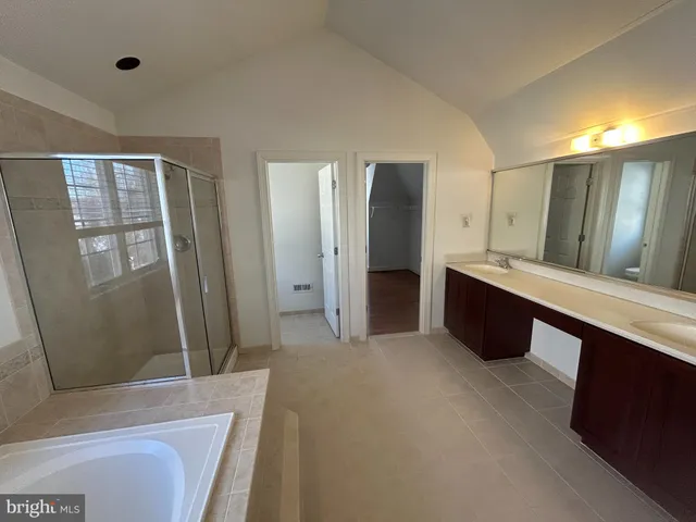 a spacious bathroom with a tub and a sink