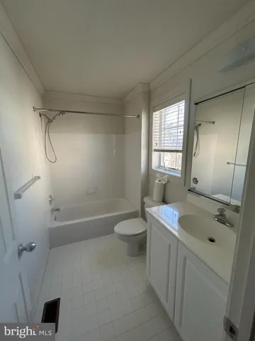 a bathroom with a granite countertop sink a toilet and shower