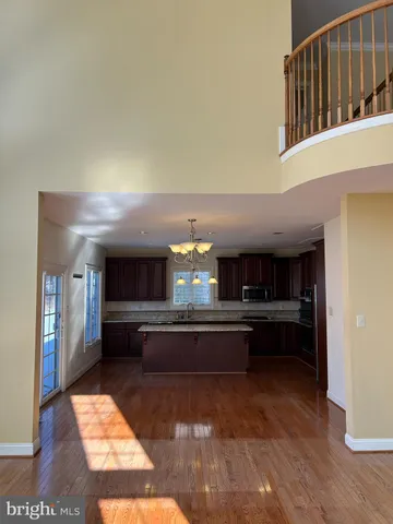 a kitchen with stainless steel appliances kitchen island granite countertop a refrigerator a stove and a sink