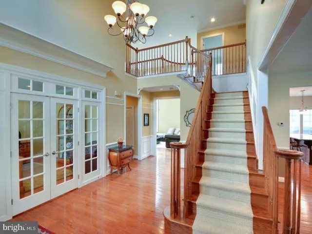a view of hall with wooden floor and front door