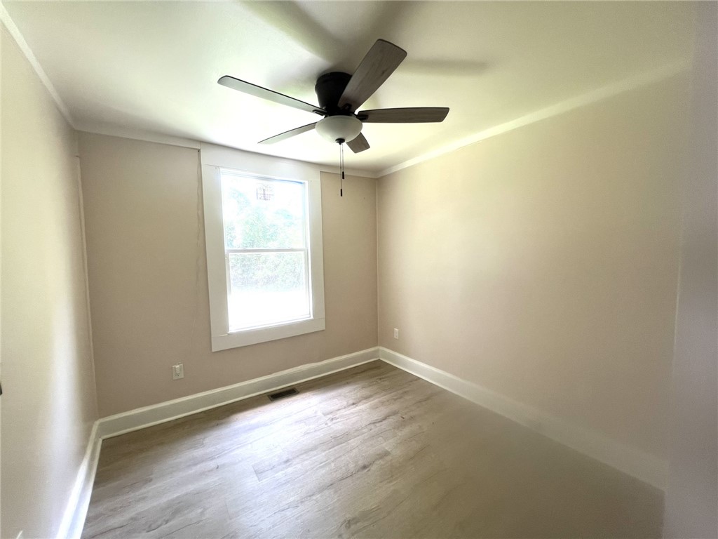 114 Shirley Street Anderson, SC 29621 - Photo 4 of 9 Bright and airy, this room features durable wood-look flooring and a ceiling fan for comfort.