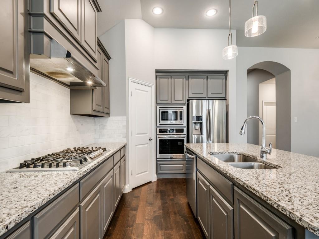 1313 Torrington Lane Forney, TX 75126 - Photo 10 of 40 a kitchen with stainless steel appliances granite countertop a sink and stove