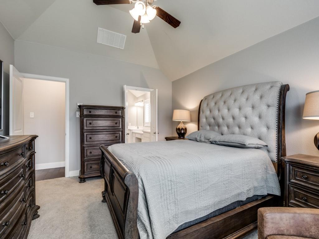 1313 Torrington Lane Forney, TX 75126 - Photo 16 of 40 a bedroom with a bed and a chandelier