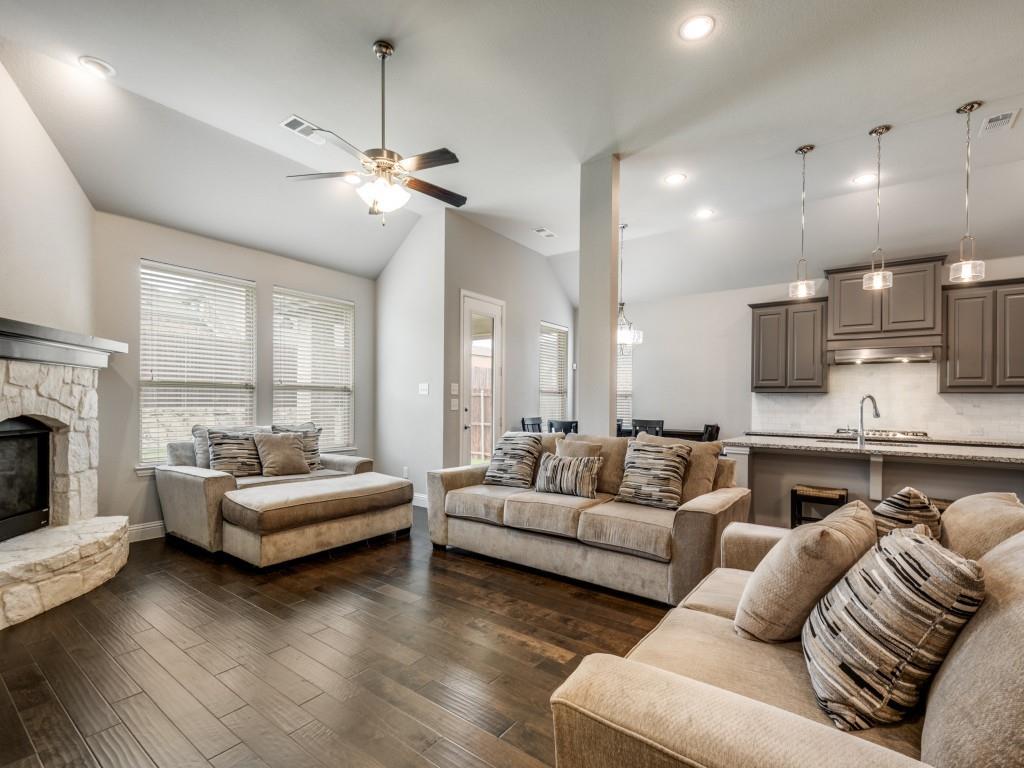 1313 Torrington Lane Forney, TX 75126 - Photo 3 of 40 a living room with furniture fireplace and a chandelier