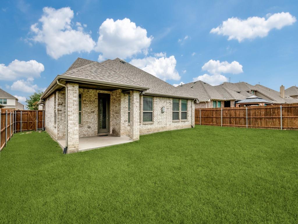 1313 Torrington Lane Forney, TX 75126 - Photo 37 of 40 a view of a house with a yard and a garden