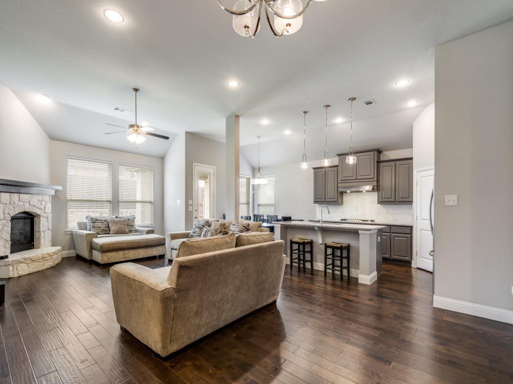 1313 Torrington Lane Forney, TX 75126 - Photo 5 of 40 a living room with stainless steel appliances kitchen island granite countertop a dining table chairs stove a refrigerator and cabinets