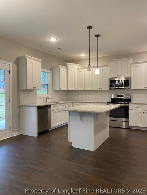 411 B & B Loop Road Raeford, NC 28376 - Photo 14 of 47 a large kitchen with stainless steel appliances granite countertop a stove a sink and a microwave